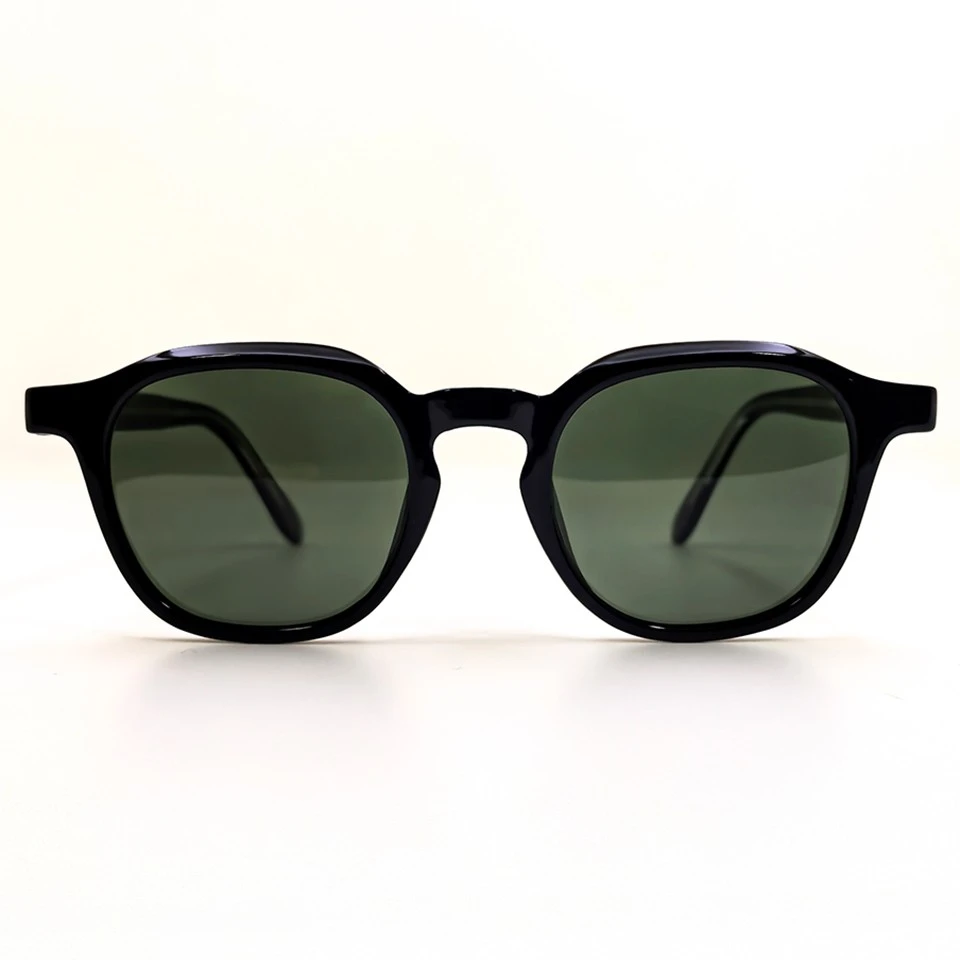 Black keyhole bridge sunglasses with green polarized lenses, temples folded Black keyhole bridge sunglasses with green polarized lenses, temples folded